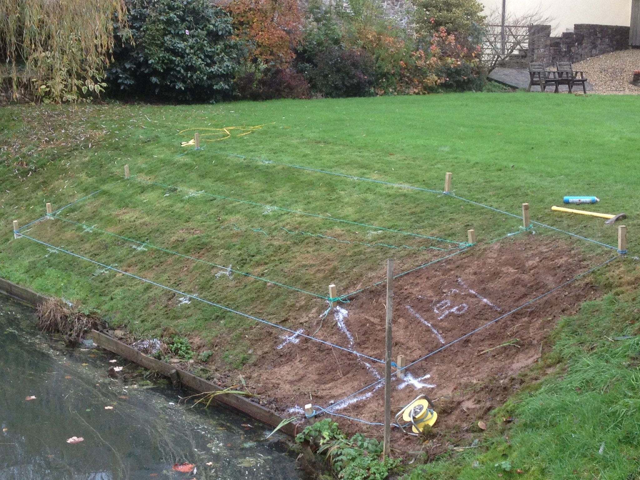 marking out the area where the hardwood deck project will be installed