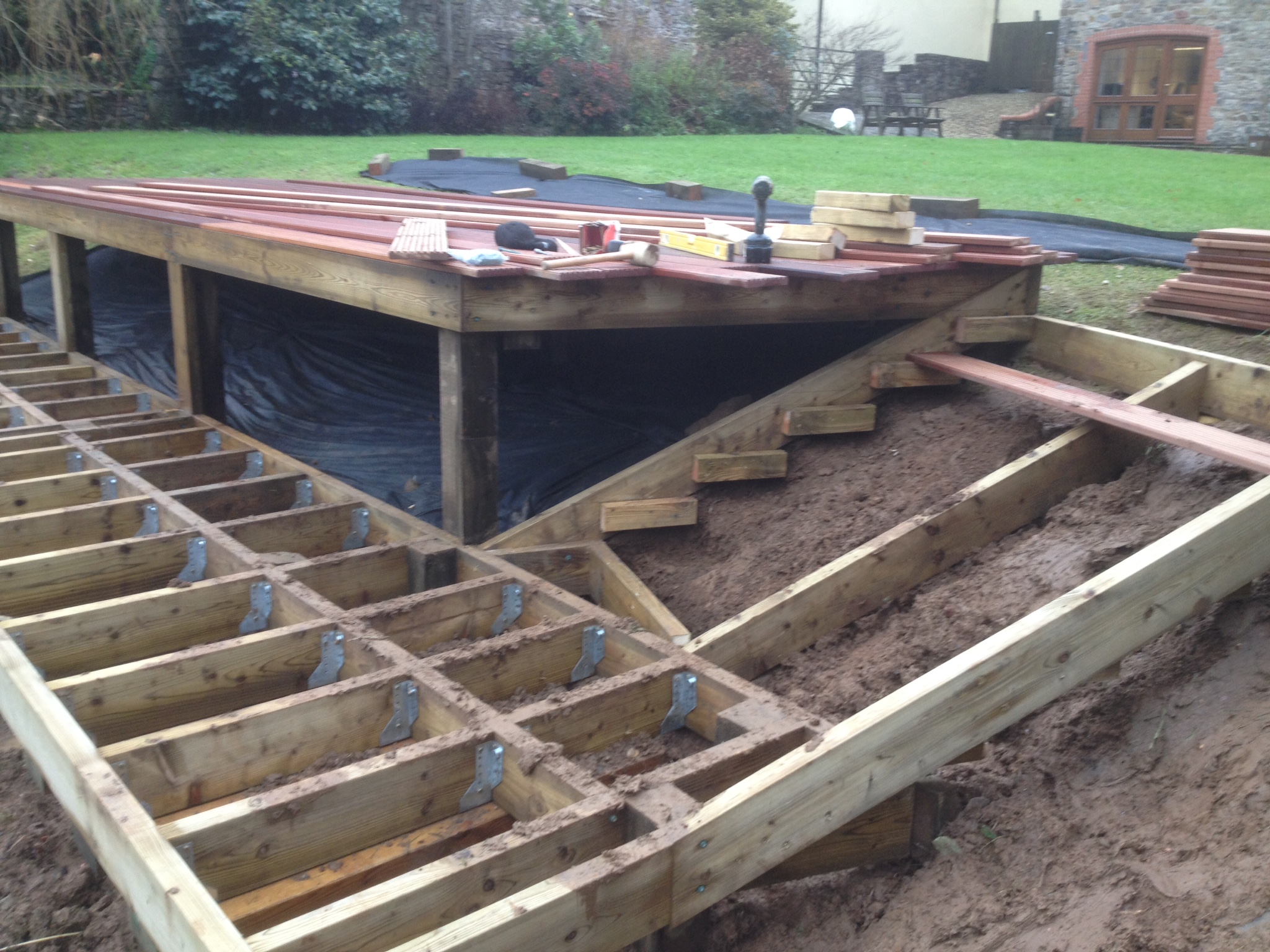 Timber framework for hardwood deck project around a lake