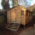 Waney edge shed on a raised platform with a pitched roof and very heavy duty