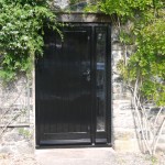 Timber painted black front door with daylight panel