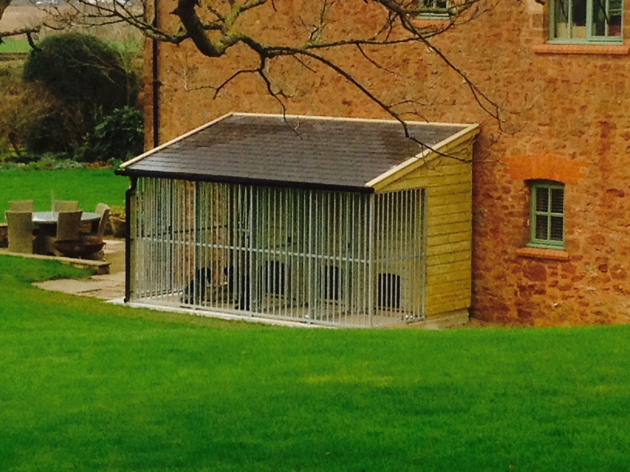 timber dog kennels with a slate roof