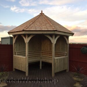 timber corner arbour with cedar shingle roof and internal seating