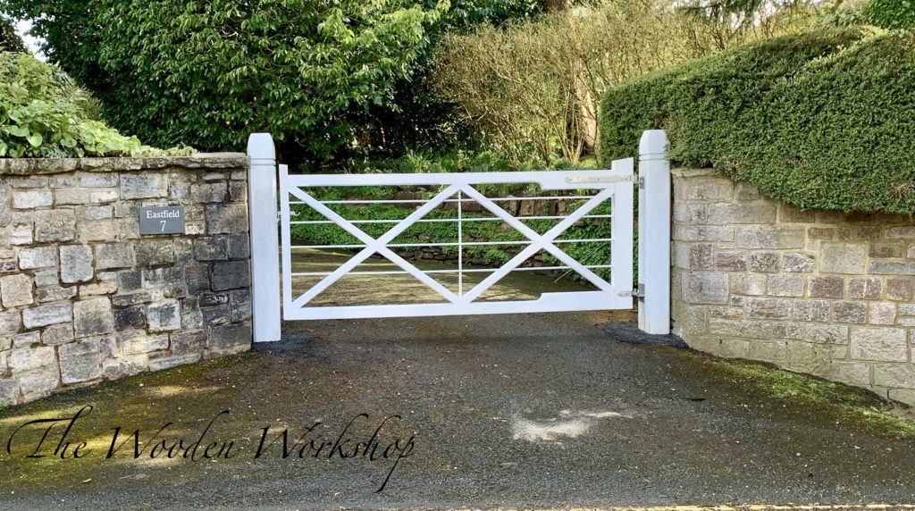 A pair of sapele gates painted white