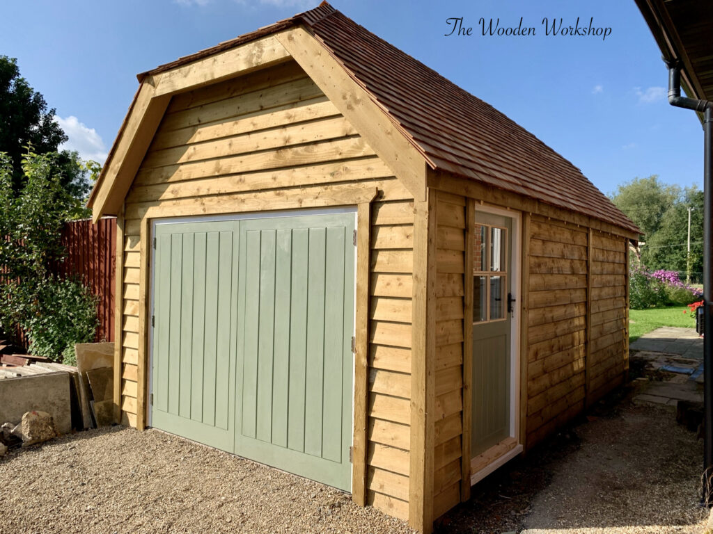 Timber garage with a hipped roof using cedar shingles - The Wooden Workshop Devon