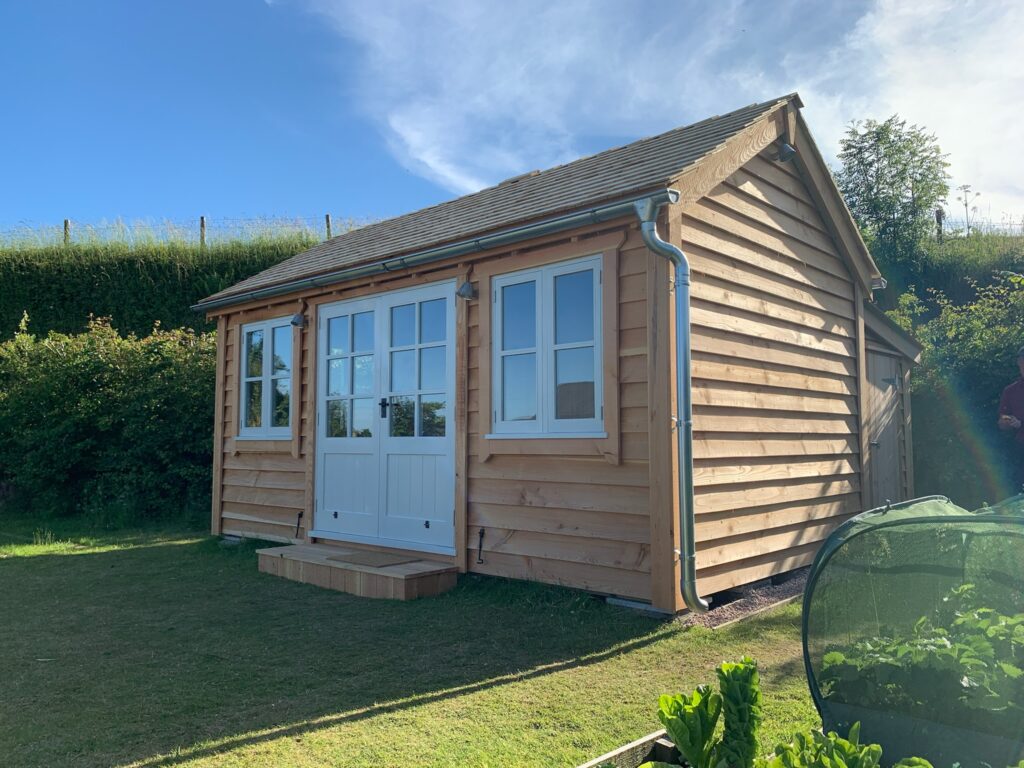 Timber garden Office With Store Room and French doors and cedar shingle roof - The Wooden Workshop Bampton Devon